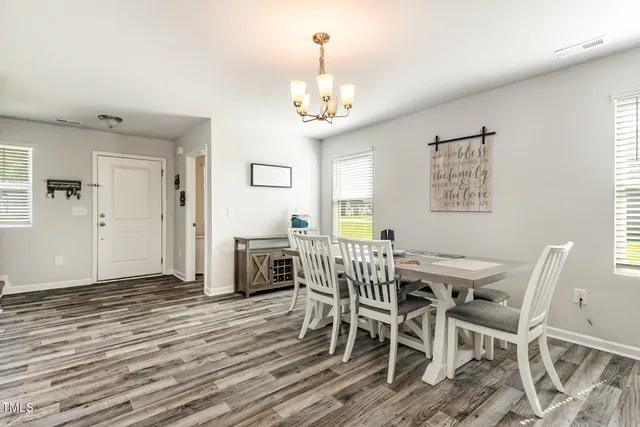 a bedroom with a bed and a lamp on table