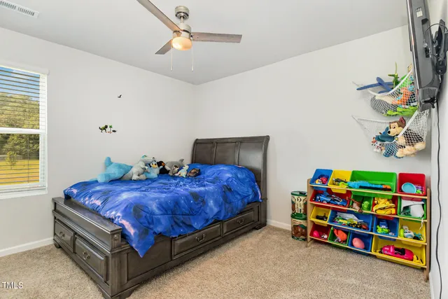 a living room with furniture and view of kitchen