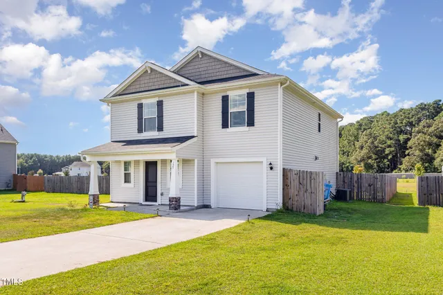 a bedroom with a bed a flat screen tv and a couch