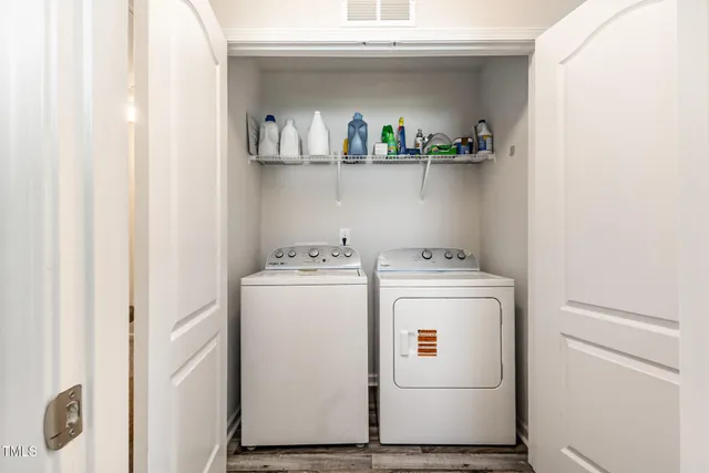 a view of a backyard with table and chairs and wooden fence