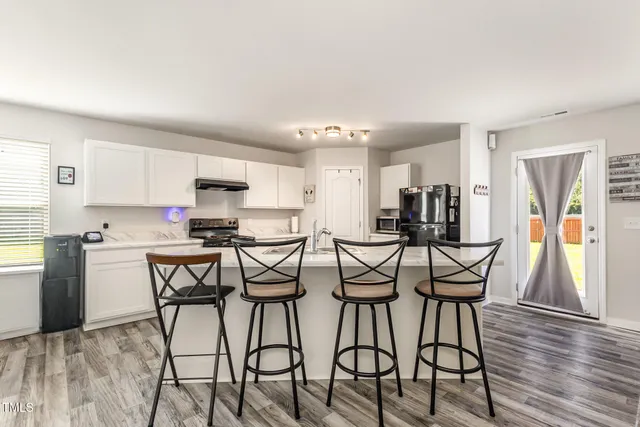 a view of a dining room with furniture and wooden floor