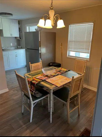 a dining room table chairs and refrigerator