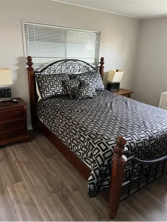 a bedroom with a bed and window