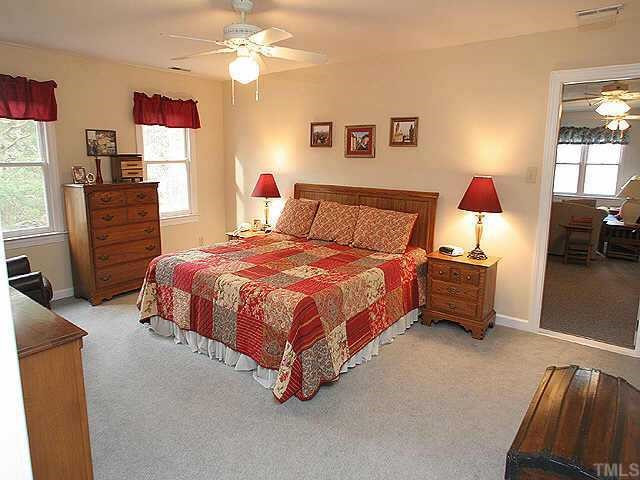 2115 Fountain Ridge Road Durham, NC 27707 - Photo 8 of 9 The spacious MBR has a ceiling fan, walk-in closet, and private bath with tiled shower and floor. Other