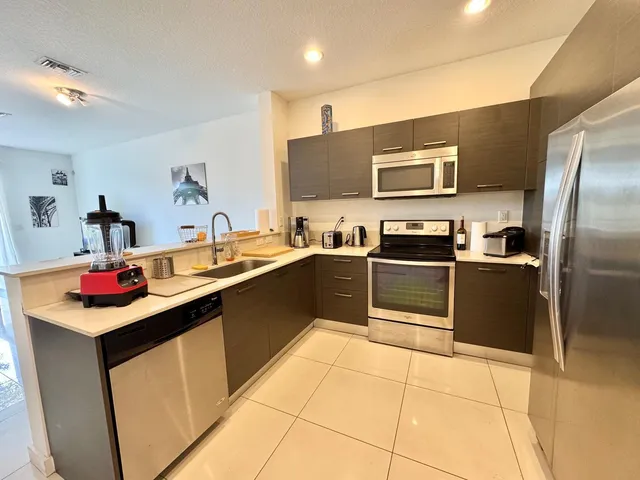 a kitchen with a sink stove and refrigerator