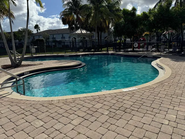 a view of a backyard with swimming pool