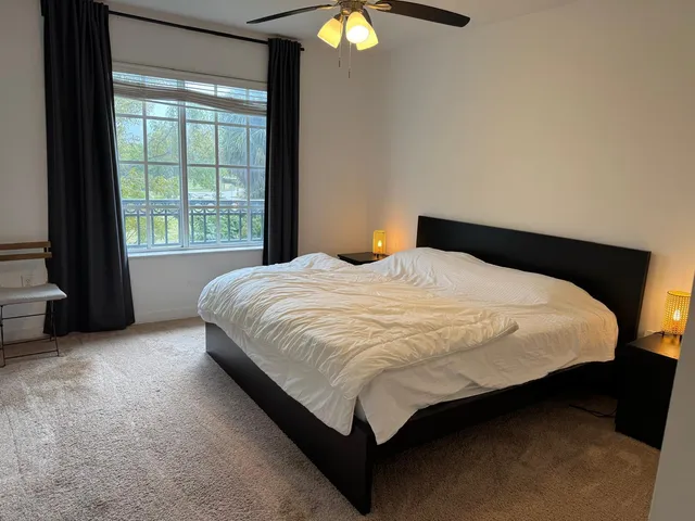 a bedroom with a bed and a window