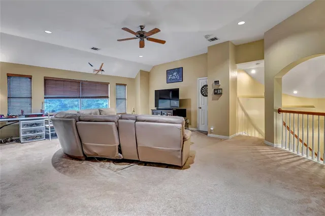 a living room with couches and kitchen view