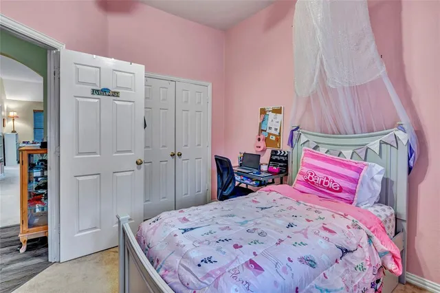 a bedroom with a bed and a dresser