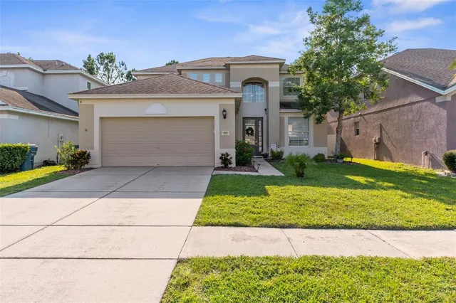 a front view of a house with a yard and garage