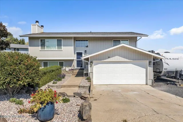 a front view of a house with a yard and a garage