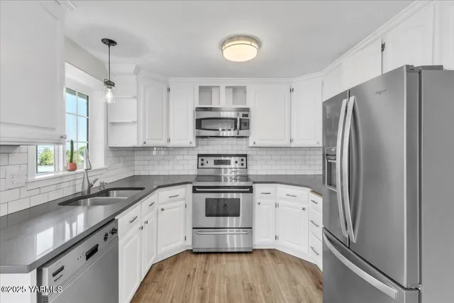 a view of an empty room and wooden floor