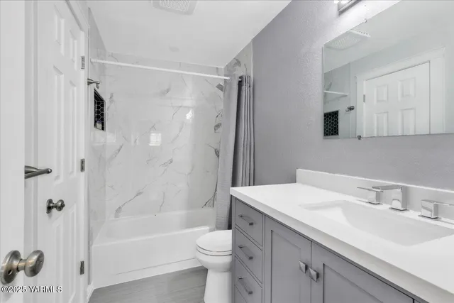 a white toilet sitting next to a bathroom sink
