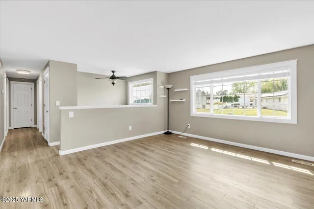 a kitchen with granite countertop stainless steel appliances and wooden floor