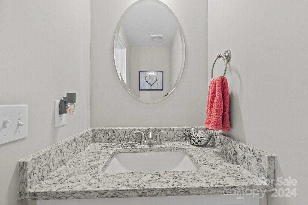 2522 Snow Creek Road Northeast Hickory, NC 28601 - Photo 14 of 24 a bathroom with a granite countertop sink and a mirror