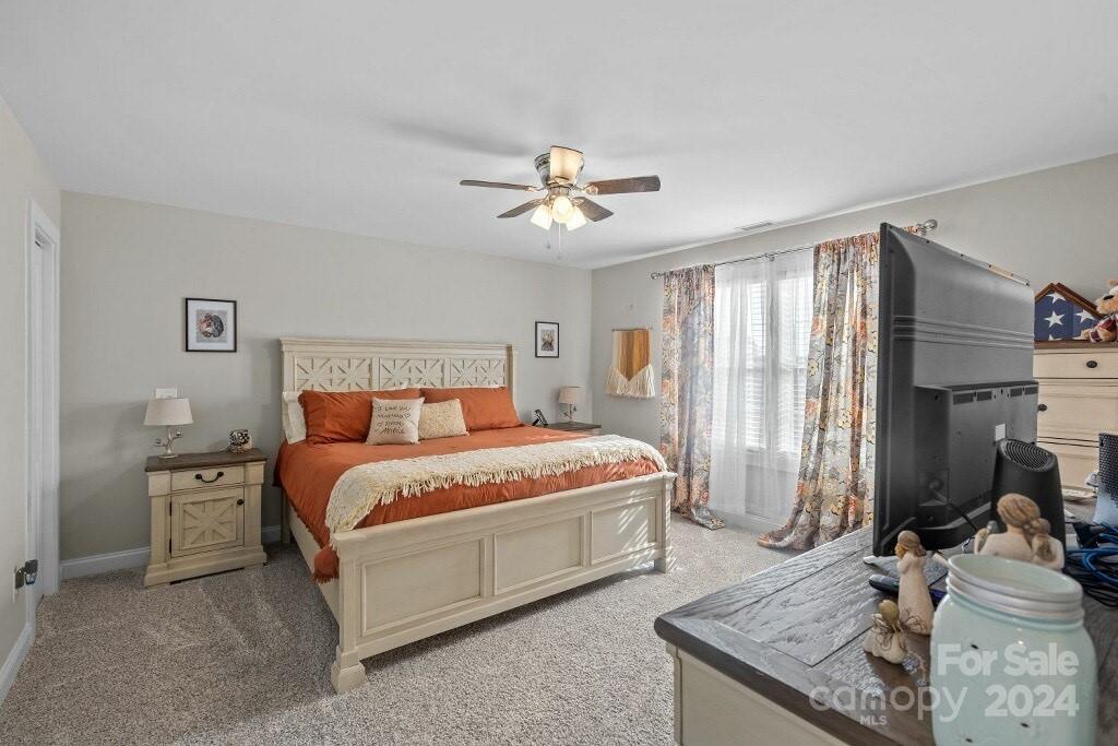 2522 Snow Creek Road Northeast Hickory, NC 28601 - Photo 18 of 24 a spacious bedroom with a bed and a chandelier