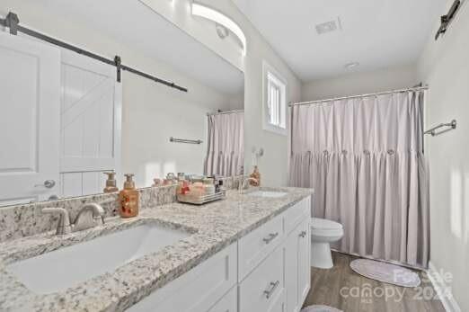 2522 Snow Creek Road Northeast Hickory, NC 28601 - Photo 20 of 24 a bathroom with double vanity sinks a mirror and a shower