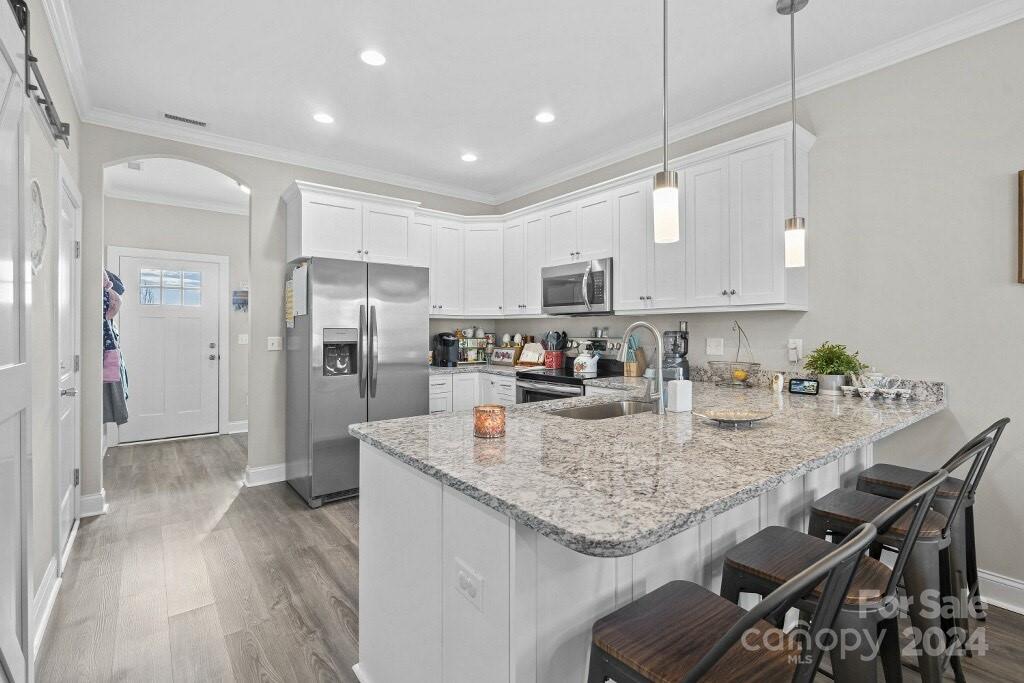 2522 Snow Creek Road Northeast Hickory, NC 28601 - Photo 2 of 24 a kitchen with kitchen island granite countertop a sink appliances cabinets a counter top space and stainless steel appliances