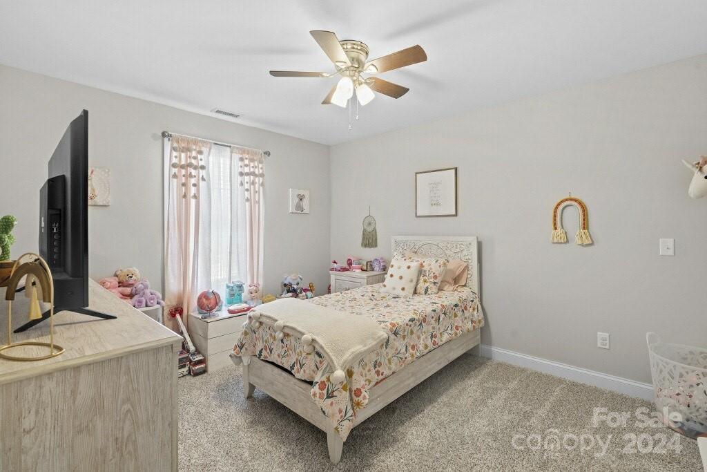 2522 Snow Creek Road Northeast Hickory, NC 28601 - Photo 22 of 24 a bedroom with a bed and a chandelier