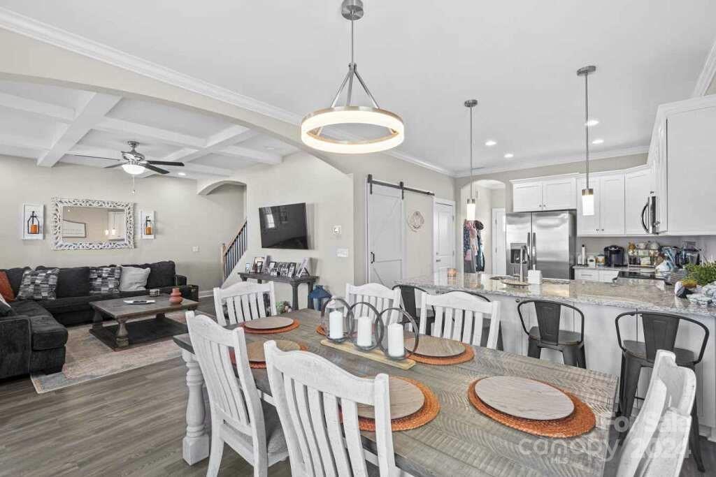 2522 Snow Creek Road Northeast Hickory, NC 28601 - Photo 6 of 24 a view of a dining room with furniture a kitchen and chandelier
