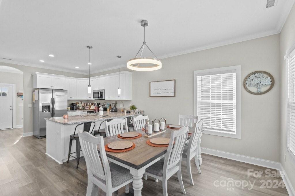 2522 Snow Creek Road Northeast Hickory, NC 28601 - Photo 9 of 24 a view of a dining room with furniture window and wooden floor
