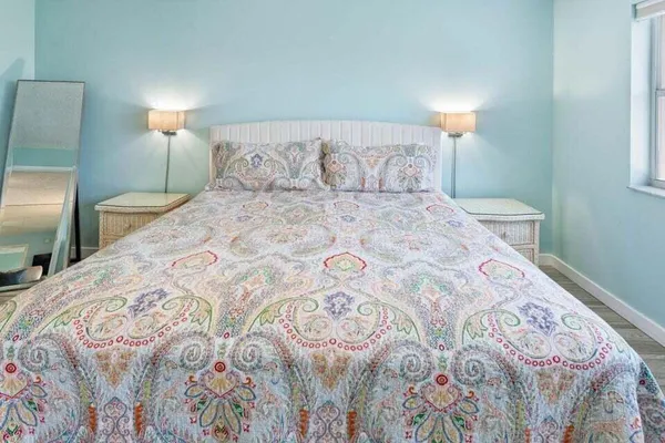a bedroom with a bed and a lamp