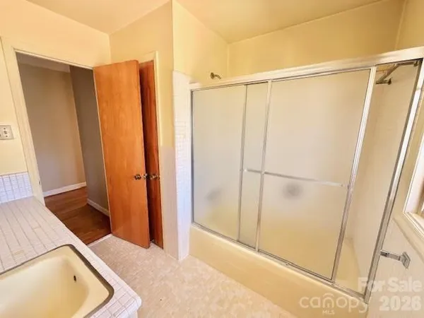 a bathroom with a tub and shower