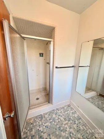 a bathroom with a glass door shower