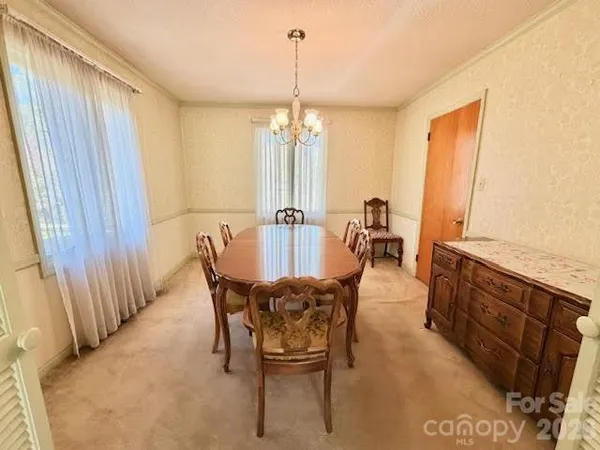 a view of a dining room with furniture and window