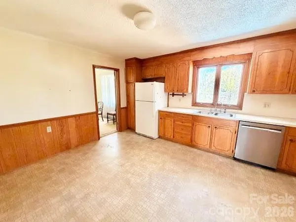 a large white kitchen with a window