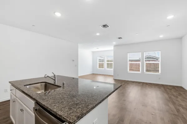 an empty room with a sink and chandelier