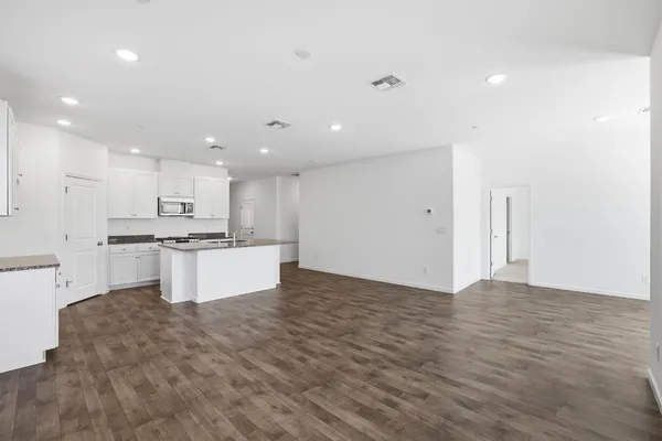 a large kitchen with stainless steel appliances kitchen island a white counter top and a stove