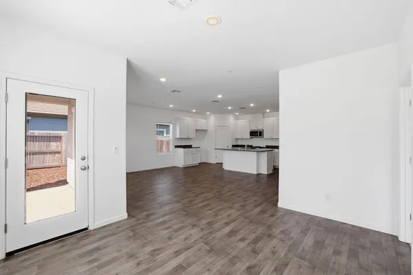 a view of kitchen with kitchen island white cabinets and wooden floor