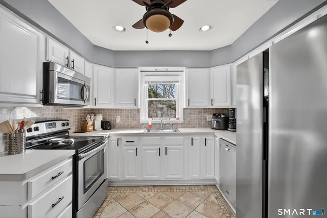 a kitchen with a stove sink and cabinets