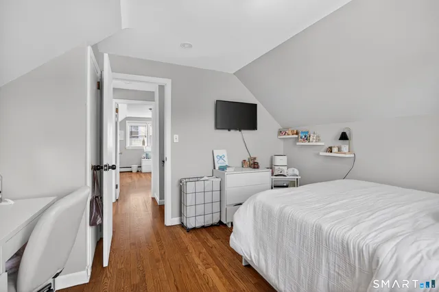 a bedroom with two bed and a flat screen tv