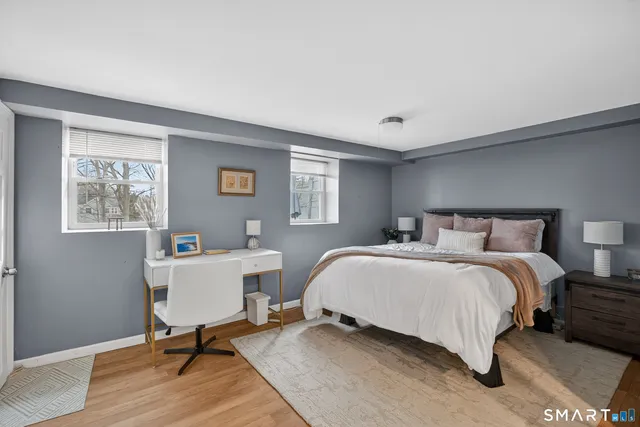 a bedroom with a bed and a desk