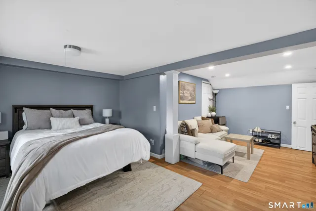 a bedroom with a bed and a night stand