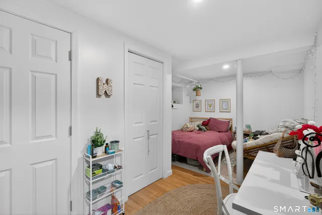 a bedroom with furniture and a book shelf