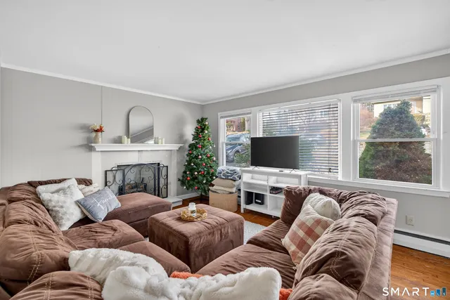 a living room with furniture fireplace and a flat screen tv