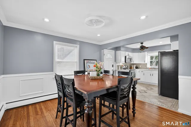 a view of a dining room with furniture and wooden floor