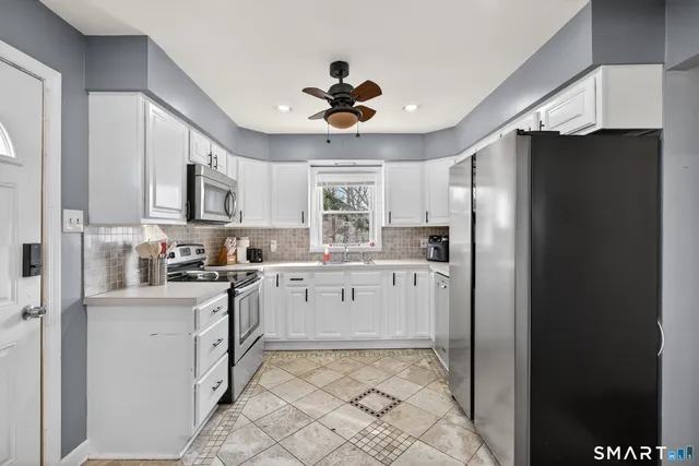 a kitchen with appliances cabinets and a sink