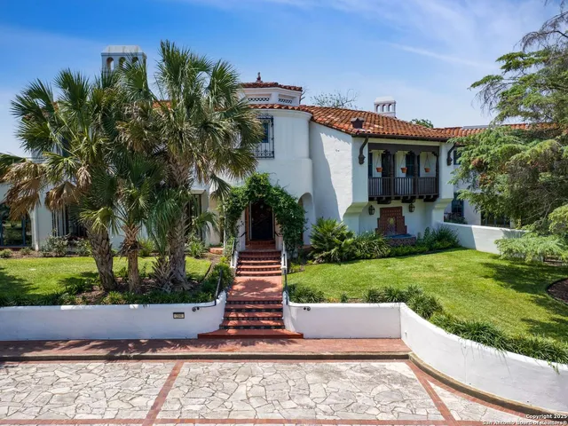 a view of a house with a yard and plants