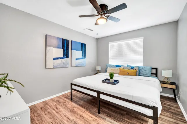 a bedroom with a bed a table and chair