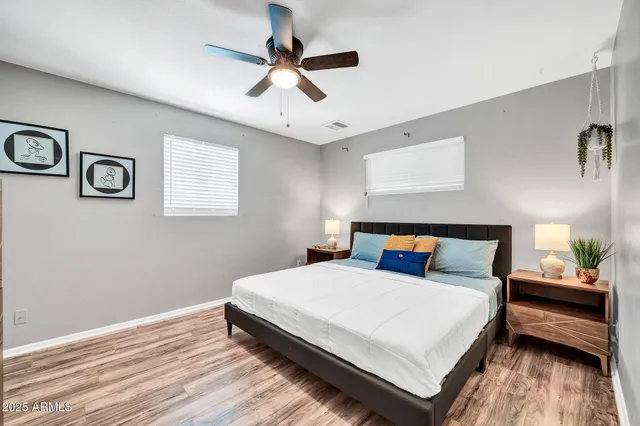 a bedroom with a bed and wooden floor