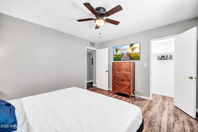 a bedroom with a bed dresser and a window