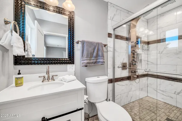 a bathroom with a sink toilet and shower