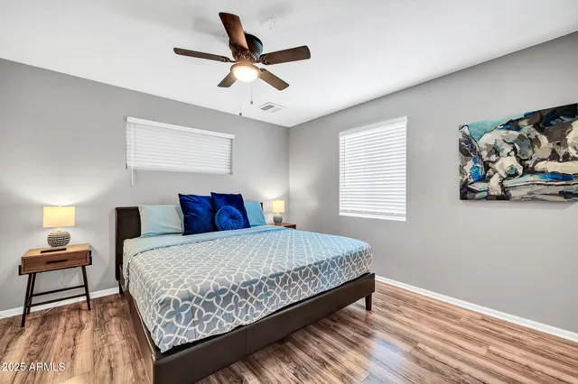 a bedroom with a large bed and a chandelier