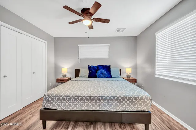 a bedroom with a large bed and a chandelier