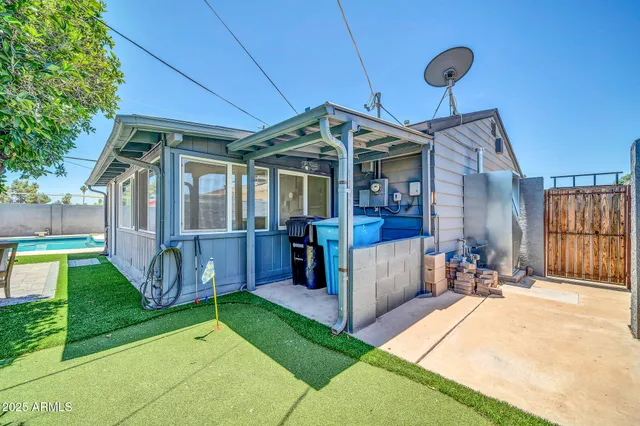 a view of a house with a patio and a yard