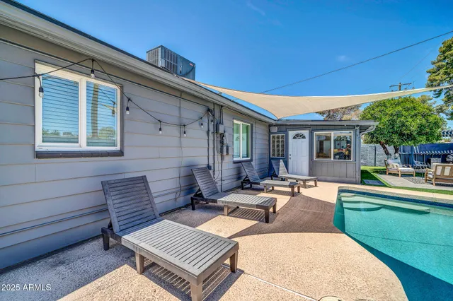 a view of a patio with couches chairs and wooden floor
